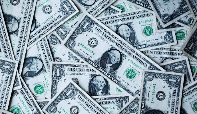 pile of U.S. dollars representing difference between costs vs investments