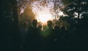 A substance use disorder treatment group watching the sunrise in the woods as part of their treatment