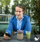 lgbtq advocate using simplepractice software on his mobile phone during lunch