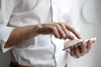 man on phone with white button down shirt