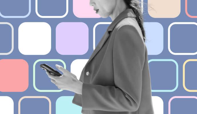 A woman holding a phone in front of a collage of purple and white squares.
