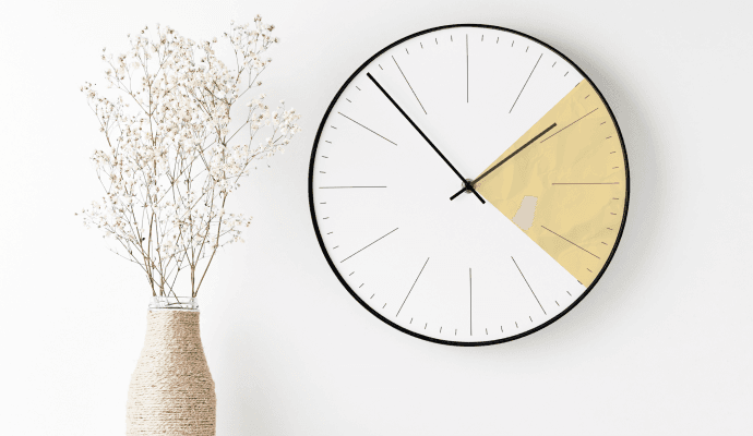 A clock hangs on the wall with a section colored yellow, showing the time in a session that can bill using the 8 minute rule.