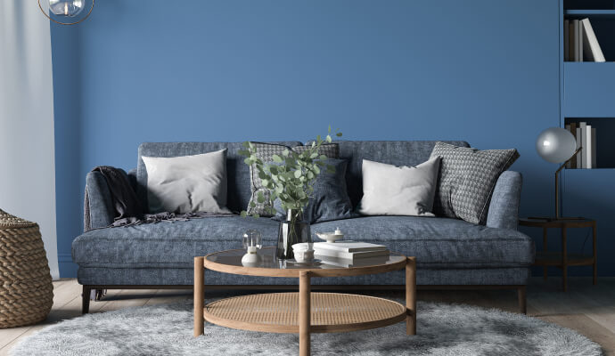 A blue wall and blue couch in a therapy office, one example of the best colors for therapy offices