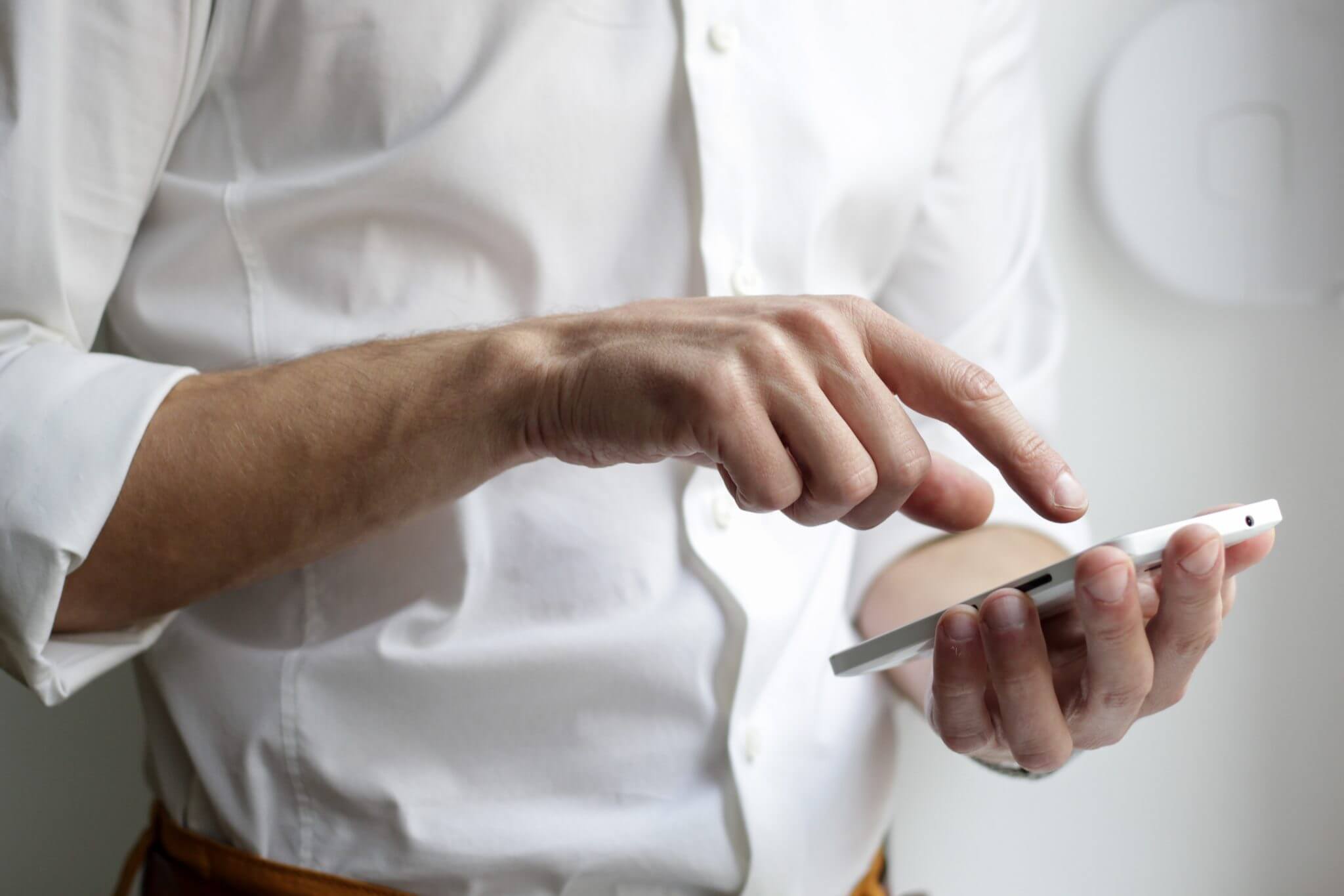 man on phone with white button down shirt