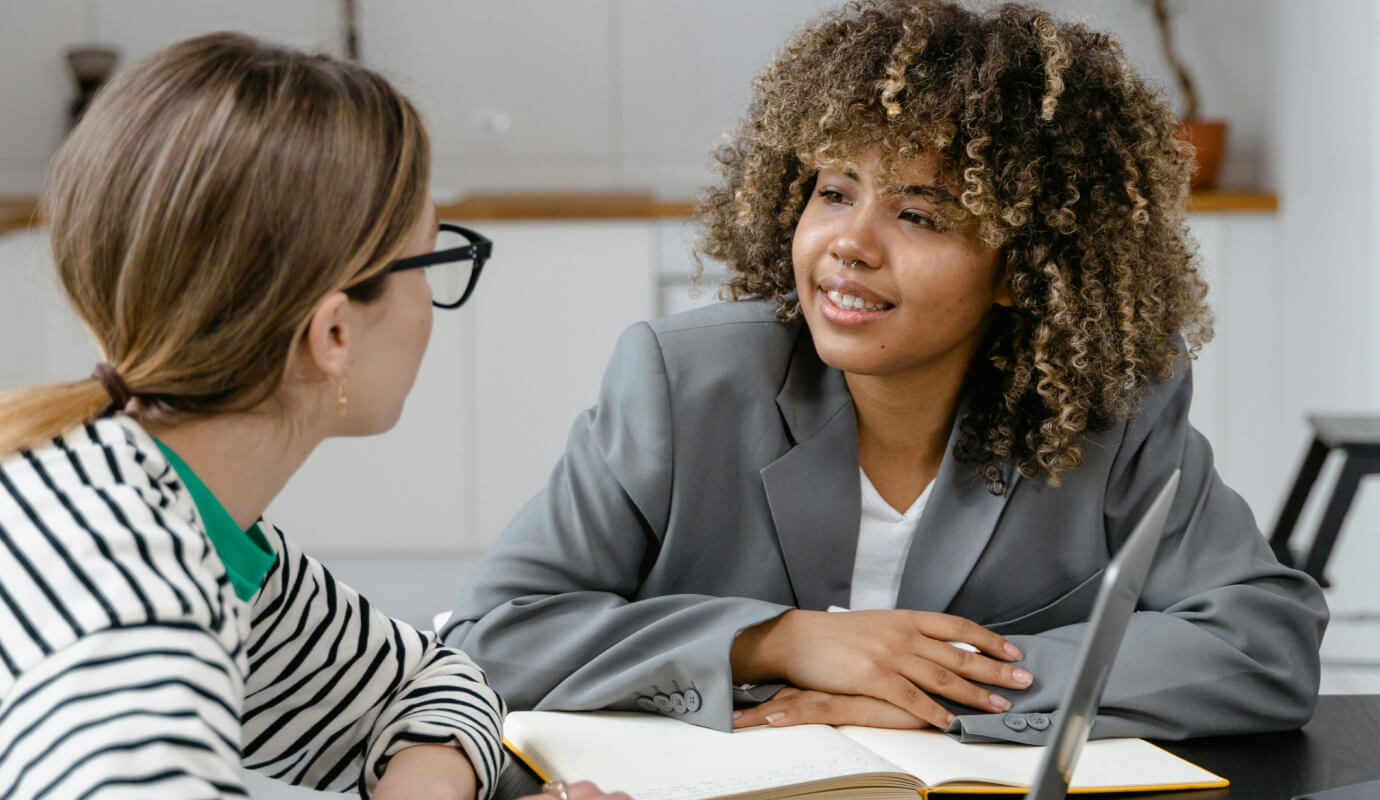 A therapist meets with a business consultant, who specializes in coaching for therapists.