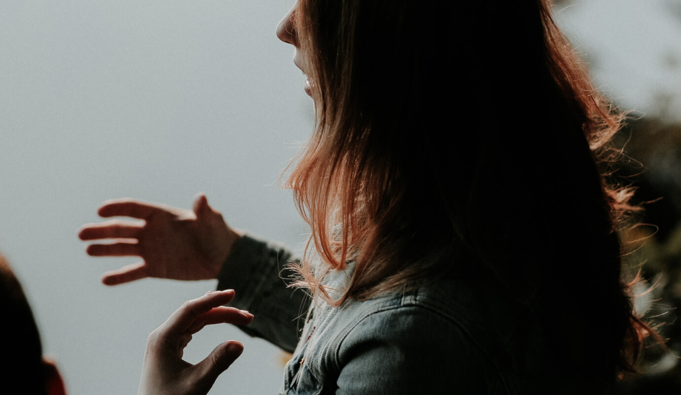 A female therapist explains the treatment plan for a client's phonological disorder.