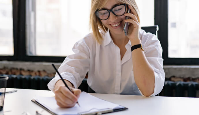 woman on the phone with a client smiling