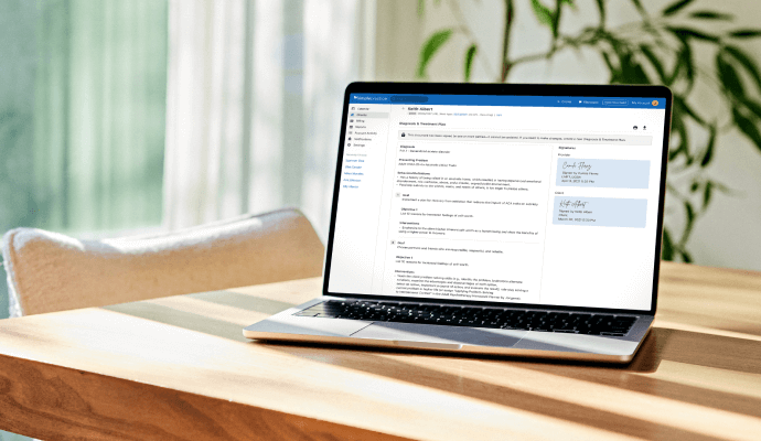 A laptop sitting on a desk showing the SOAP note subjective section being drafted by a therapist