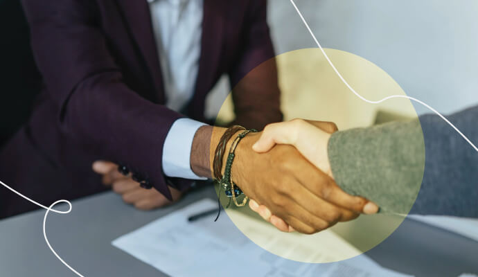 An image of two people shaking hands with a collage of light colors overlaying it.